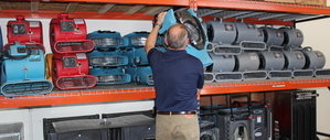 Water Damage Restoration Technician Prepping Air Movers