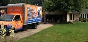 Water Damage Restoration Truck Parked Near Lawn